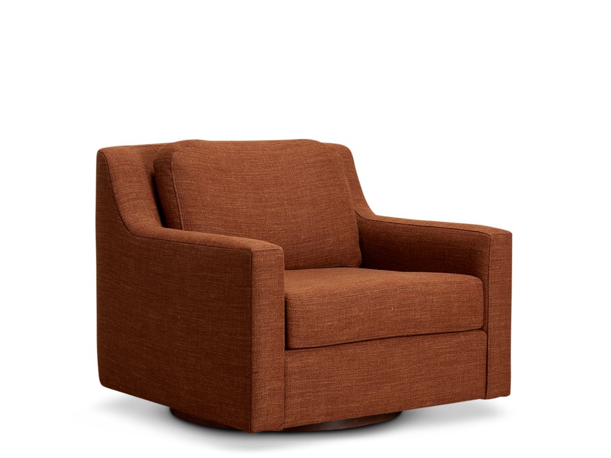 A burnt orange armchair with a low back and wide arms